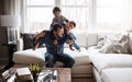 Goofy, funny and bonding father with children on the sofa for playing, quality time and crazy fun. Love, happy and boy Royalty Free Stock Photo