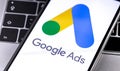 Google Ads logo on the screen smartphone with notebook Royalty Free Stock Photo