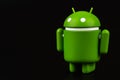 Google Android figure on a black background. Google Android is the operating system for smartphones, tablet computers and other