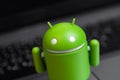 Google Android figure on notebook background closeup Royalty Free Stock Photo