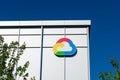 Google Cloud logo in the shape of cloud is displayed on Google campus building. The colors found in the logo are blue, red, yellow