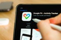 Google fit logo shown by apple pencil on the iPad Pro tablet screen. Man using application on the tablet. December 2020 Royalty Free Stock Photo