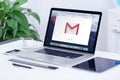 Google Gmail logo on Apple MacBook display on office desk