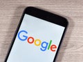 Google logo on the smartphone screen. Google is an American multinational internet and technology company. Royalty Free Stock Photo
