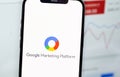 Google Marketing Platform logo on screen smartphone  and notebook background closeup Royalty Free Stock Photo