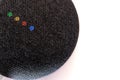 A Google Nest Mini smart Speaker on white surface