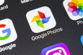 Google Photos application icon on Apple iPhone X screen close-up. Google Photos icon. Google photos application. Social media netw