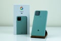 Google Pixel 5 in Sorta Sage color next to its box. Royalty Free Stock Photo