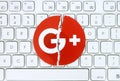 Google plus icon torn and put on white keyboard