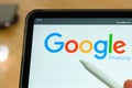 Google shopping logo shown by apple pencil on the iPad Pro tablet screen. Man using application on the tablet. December 2020, San Royalty Free Stock Photo