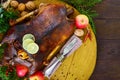 Goose baked in the oven with apples. Christmas goose on a wooden tray.