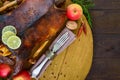 Goose baked in the oven with apples. Christmas goose on a wooden tray.