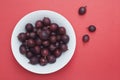 Gooseberries in a bowl on red background with space for copy text.