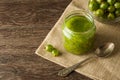 Gooseberry smoothie in a jar on a brown table