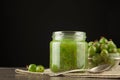 Gooseberry smoothie in a jar on a brown table