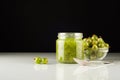 Gooseberry smoothie in a jar on a white table