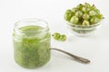 Gooseberry smoothie in a jar on a white table