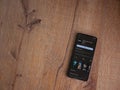 GoPro Quik - Video Editor app play store page on smartphone on wooden background.