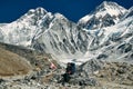 Nepali porter on a trail on a sunny day wanders through the beautiful Himalayan valley. Royalty Free Stock Photo