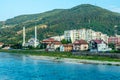 Gorazde residential district town panorama with mosque on the riverbank and Drina river in the foreground, Bosnia and Herzegovina