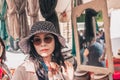 Gordes, Provence-Alpes-Cote d`Azur, France, September 25, 2018: Chinese tourist trying on hat