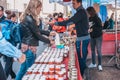 Gordes, Vaucluse/France - September 25, 2018: Attractive cute blonde tastes and buys spices and sauce on the market