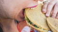 Gorditas de maiz stuffed with chicharrÃÂ³n, traditional Mexican street food, with a girl eating the