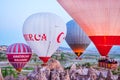 GOREME, CAPPADOCIA, TURKEY - APRIL 19, 2018: Colorful hot air balloon flying over rock landscape at Cappadocia, Turkey