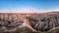 Goreme, Cappadocia, Turkey : panoramic view of colorful hot air balloons flying over the Red valley on sunrise Royalty Free Stock Photo
