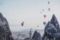 Goreme, Cappadocia, Turkey : view of colorful hot air balloons flying over the Red valley on sunrise. toned