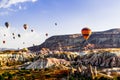 Colorful hot air balloons flying over the valley at Cappadocia, Anatolia, Turkey. Royalty Free Stock Photo