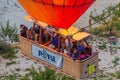 GOREME, TURKEY - JULY 21, 2019: People in a gondola of hot air balloon above Cappadocia landscape, Turk