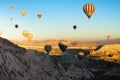 Morning view of air balloons festival in Cappadocia. Hot air balloons fly over rocks. Scenic landscape with unusual rock formation Royalty Free Stock Photo