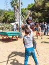 A knight festival participant dressed in a samurai costume fights with a small visitor on foam rubber swords in Goren park in Isra