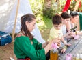 A participant in the knight festival shows visitors how to prepare aromatic drugs in Goren park in Israel