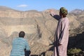 A Guide Shows a Tourist the Landscape around Jabel Shams.