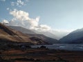 Gorge of the Kali Gandaki river with high cliffs and the valley with farm fields and sunset rays