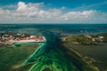 Gorgeous aerial view of the Split in Caye Caulker, Belize with turquoise water under a cloudy sky
