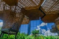 Gorgeous architectural woodden structure, with some vegetation behind, in a botanical greenhouse in Medellin