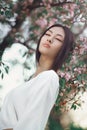 Asian woman outdoors on spring against flower blossom Royalty Free Stock Photo