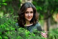 Attractive girl in green dress stand in spring green park