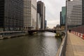 a gorgeous autumn landscape along the Chicago River with cars driving over a bridge and office buildings and skyscrapers Royalty Free Stock Photo