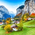 Gorgeous autumn landscape of alpine village Lauterbrunnen with famous church and Staubbach waterfall