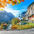 Gorgeous autumn landscape of alpine village Lauterbrunnen with famous church and Staubbach waterfall