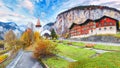 Gorgeous autumn landscape of  alpine village Lauterbrunnen with famous church and Staubbach waterfall Royalty Free Stock Photo