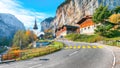 Gorgeous autumn landscape of  alpine village Lauterbrunnen with famous church and Staubbach waterfall Royalty Free Stock Photo