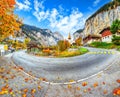 Gorgeous autumn landscape of  alpine village Lauterbrunnen with famous church and Staubbach waterfall Royalty Free Stock Photo