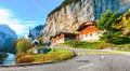 Gorgeous autumn landscape of  alpine village Lauterbrunnen with famous church and Staubbach waterfall Royalty Free Stock Photo