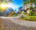 Gorgeous autumn landscape of  alpine village Lauterbrunnen with famous church and Staubbach waterfall Royalty Free Stock Photo