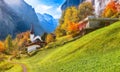 Gorgeous autumn landscape of  alpine village Lauterbrunnen with famous church and Staubbach waterfall Royalty Free Stock Photo